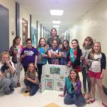 Gina with Girl Scouts participating in an environmental activity.